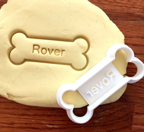 Pet Faves | Personalized Dog Treat Cookie Cutter | The way through to a dog parent's heart is through their dog's stomach. And the way to a dog's stomach is treats especially treats with their name on them! Adding a personalized dog treat cookie cutter to a dog treat recipe jar gift will win over both pet parent and dog.